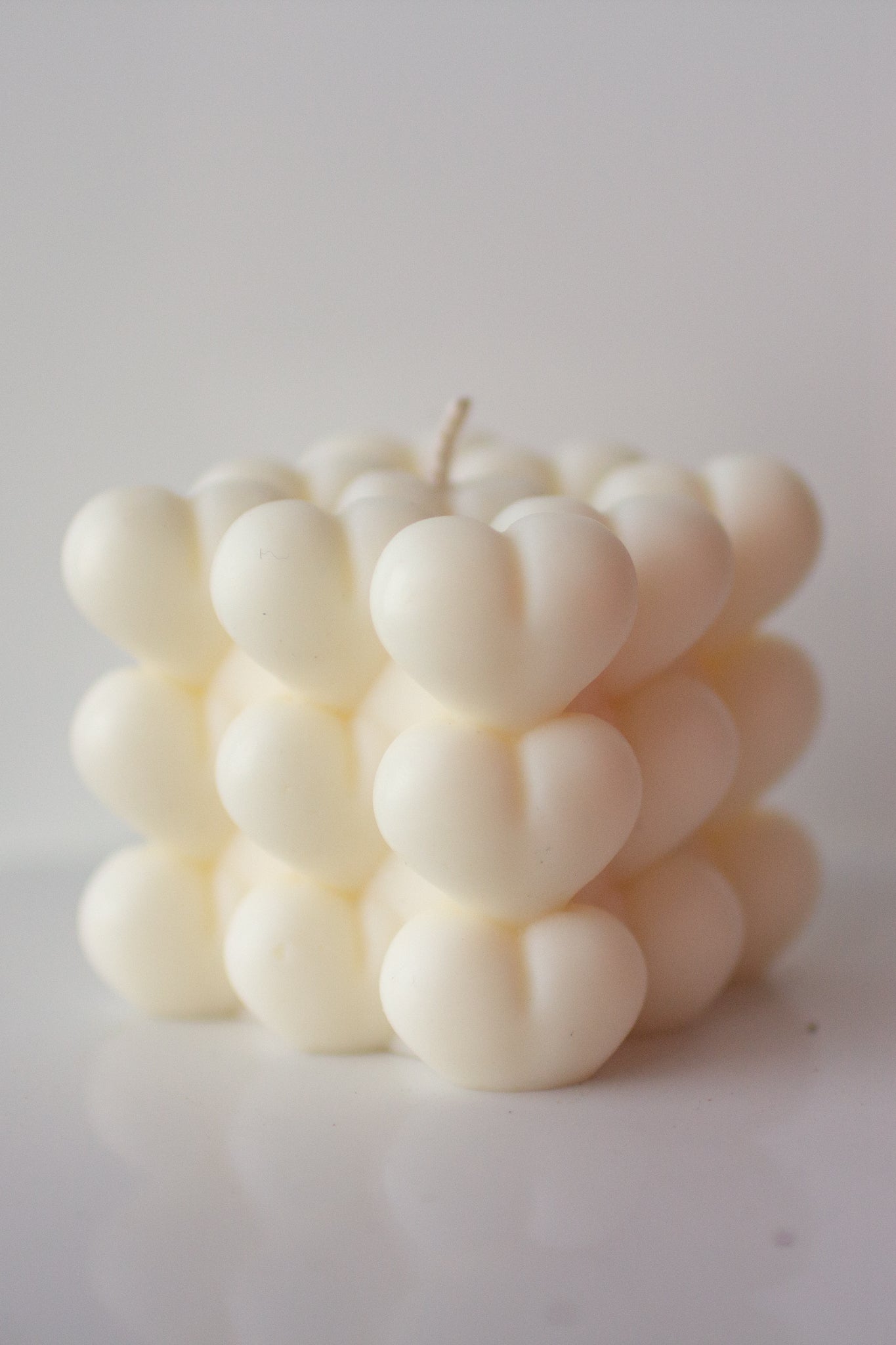 Cube shaped candle with bubble hearts